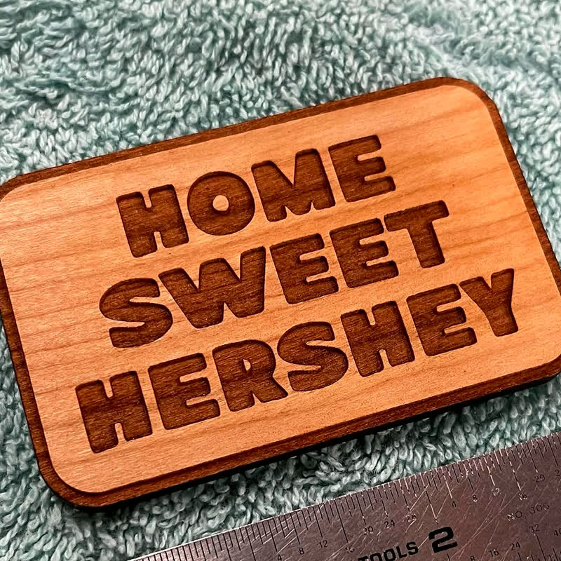 A cherry wood magnet laser-engraved with the words Home Sweet Hershey